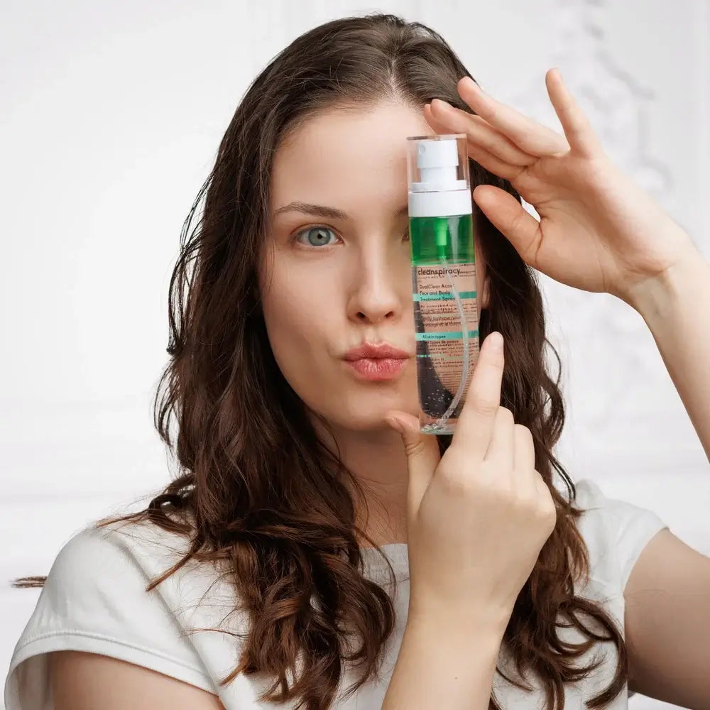 Girl Holding DualClear Skin Acne Body and Face Treatment Bottlespray