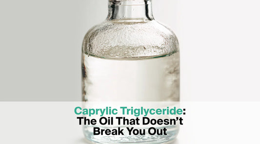  A clear glass bottle contains a clear liquid, with the text overlay "Caprylic Triglyceride: The Oil That Doesn't Break You Out".