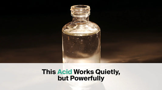  A small, clear glass bottle with a clear liquid inside is presented against a dark background, with the text overlay "This Acid Works Quietly, but Powerfully".