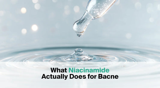  A glass dropper releases a clear drop of liquid onto a water surface creating ripples, with the text overlay "What Niacinamide Actually Does for Bacne".